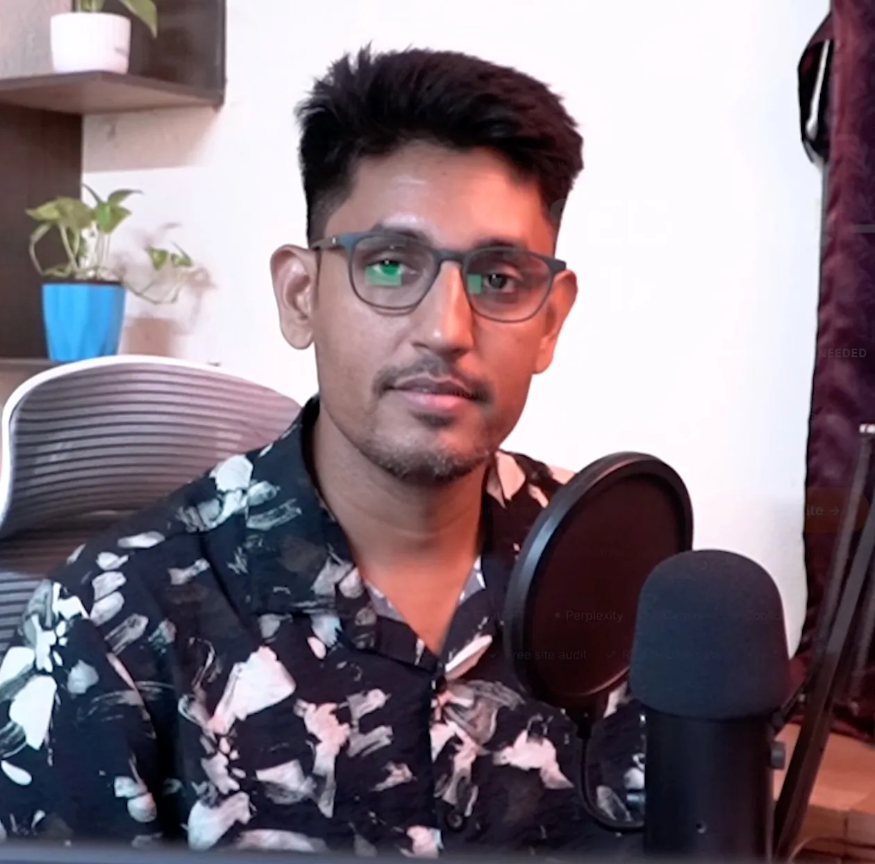 Sandipan Das at his desk in the Kolkata office, microphone in front of him